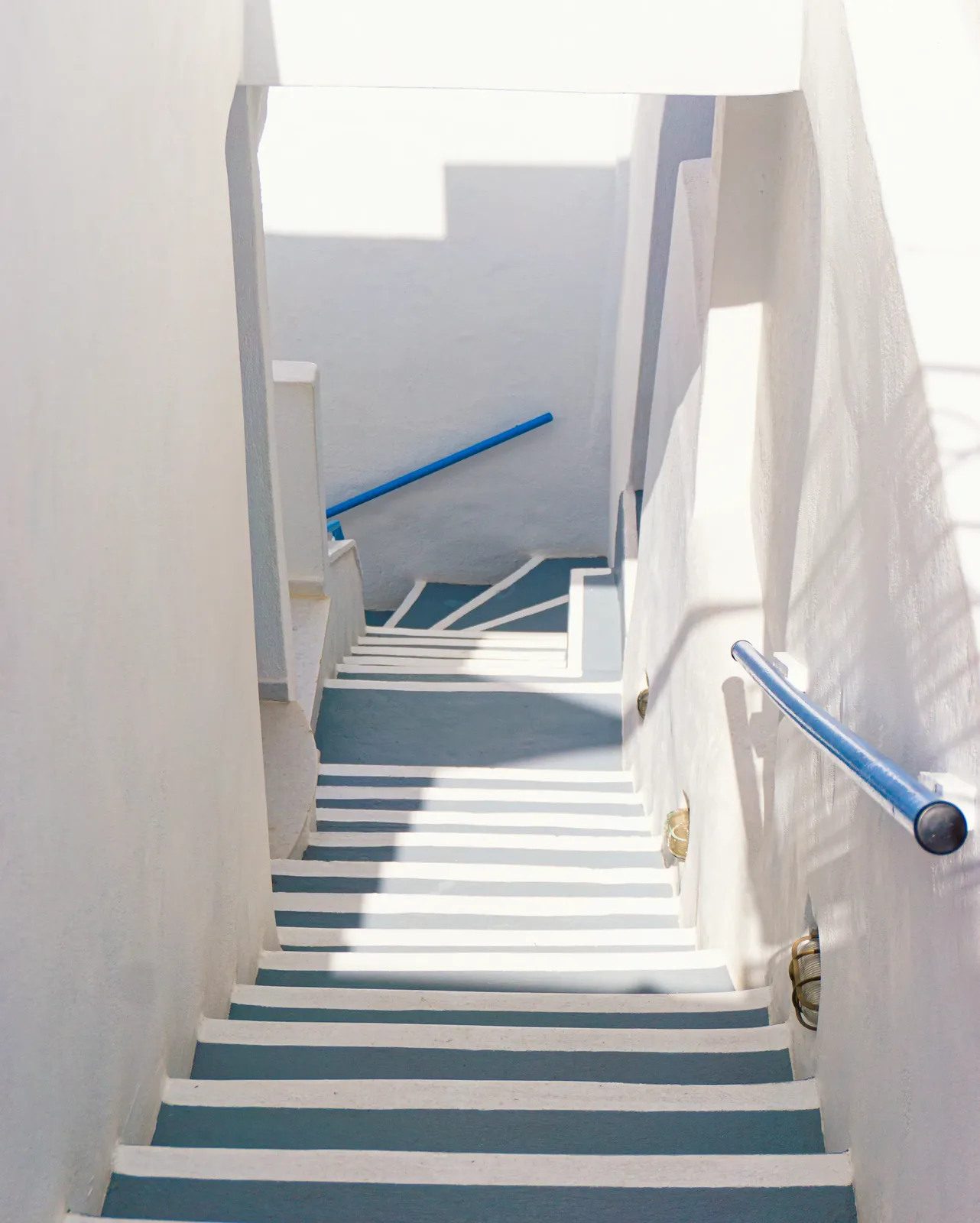 The whitewashed steps down to the apartments